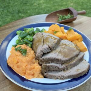 Roast beef meal with gravey, pumpkin, mashed sweet potato, peas and beans