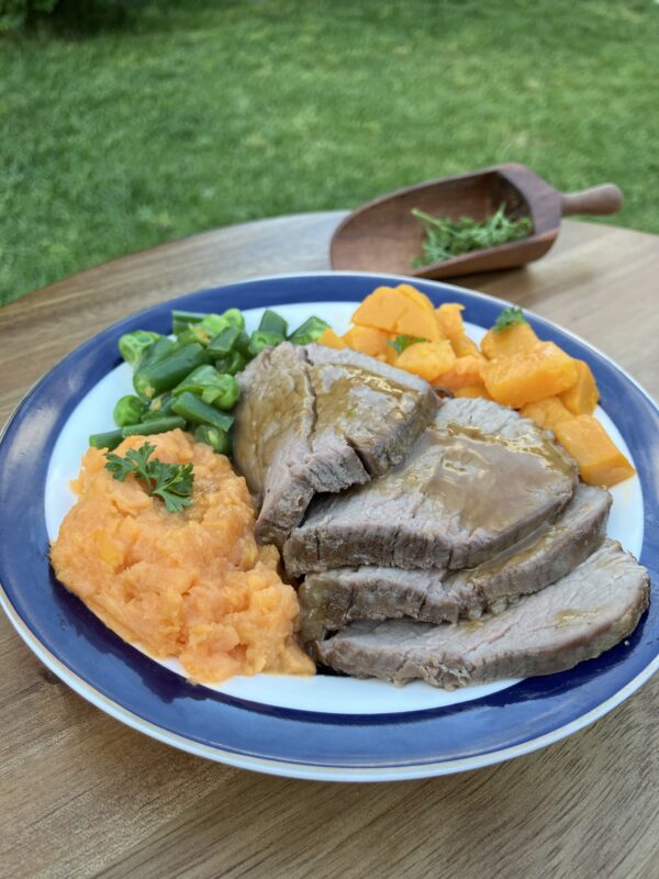 Roast beef meal with gravey, pumpkin, mashed sweet potato, peas and beans